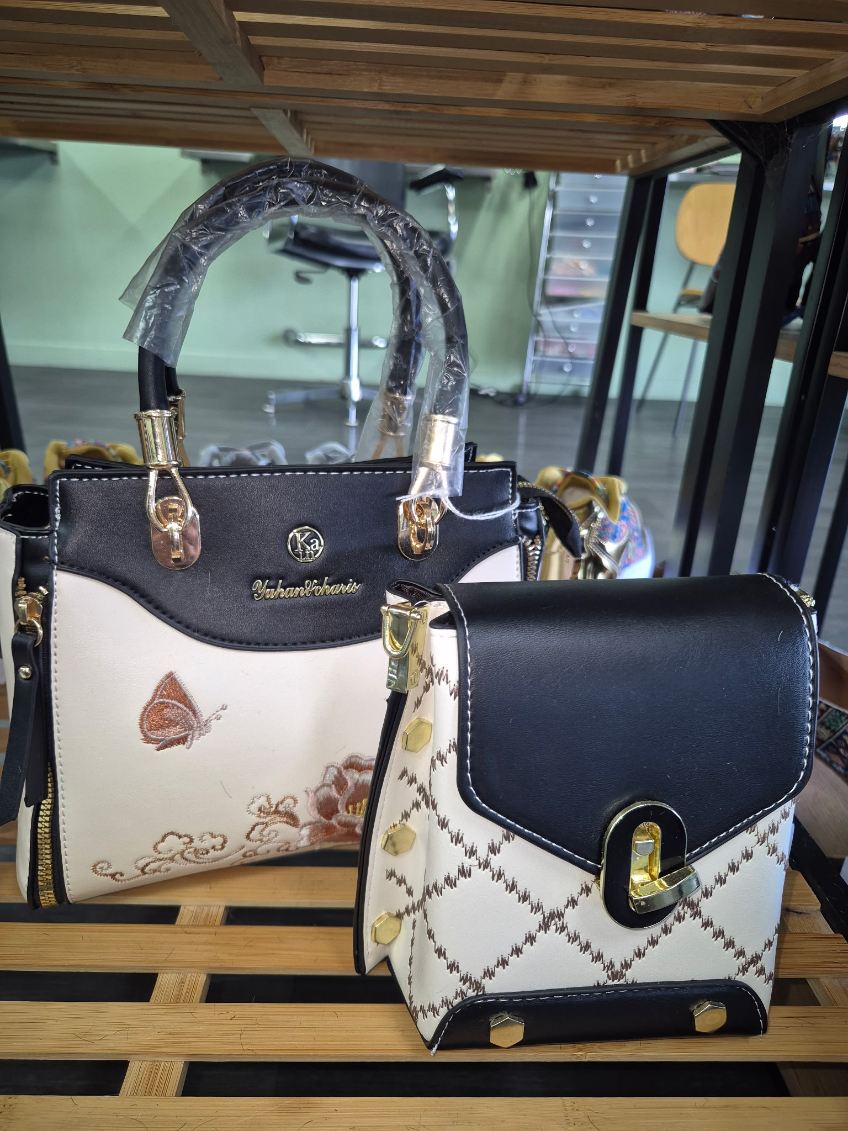 Black and cream handbags with butterfly and patterned details