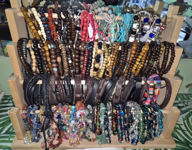 A display of colourful beaded bracelets and woven wristbands